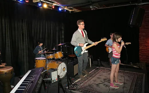 a group of people playing instruments on a stage