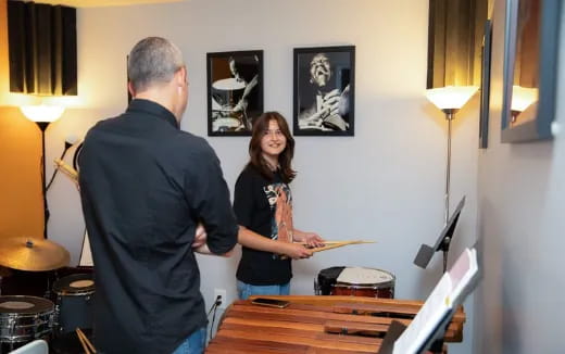 a man and a woman playing the piano