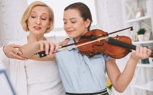 a boy and girl playing violin