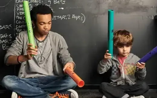 a person and a boy holding baseball bats