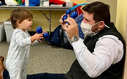 a person and a child playing with toys