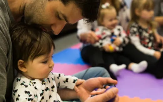 a person and a child playing with a remote control