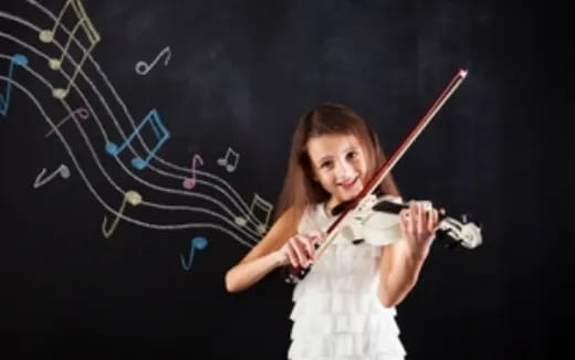 a girl holding a violin