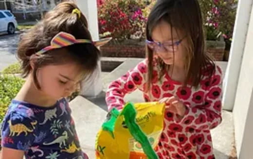 a couple of girls playing with a toy