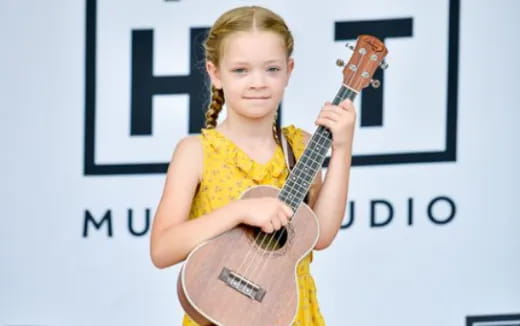 a girl holding a guitar