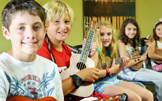 a group of kids holding guitars