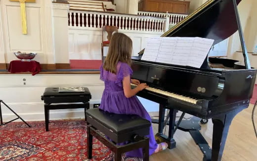 a girl playing the piano