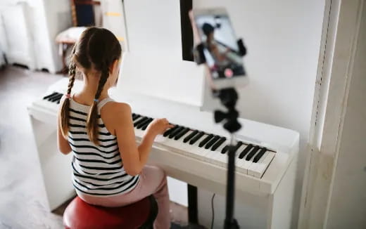 a woman playing a piano