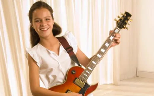 a woman holding a guitar