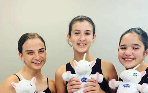a group of girls holding stuffed animals