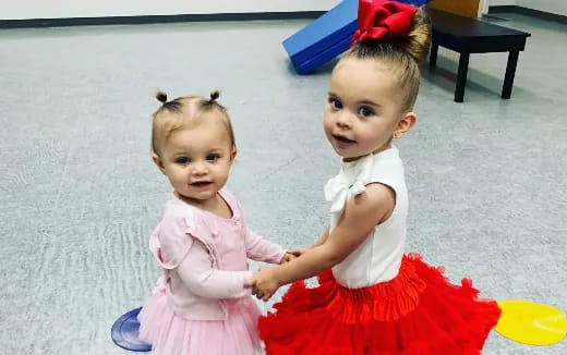 two children wearing dresses