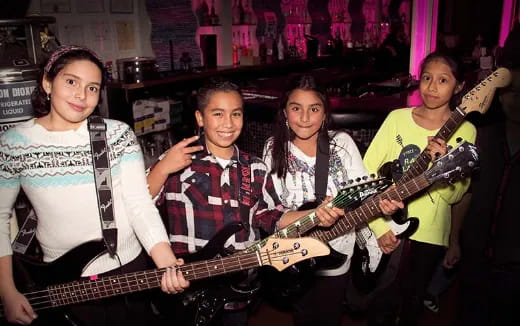 a group of people holding guitars