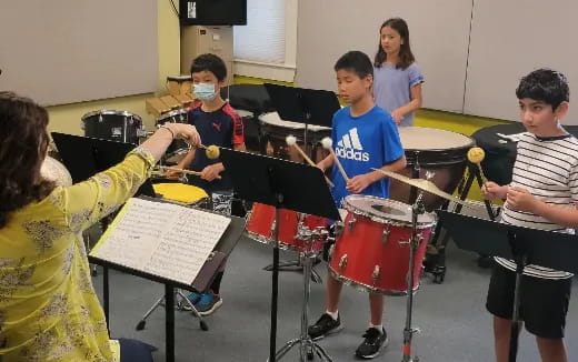 a group of kids playing drums