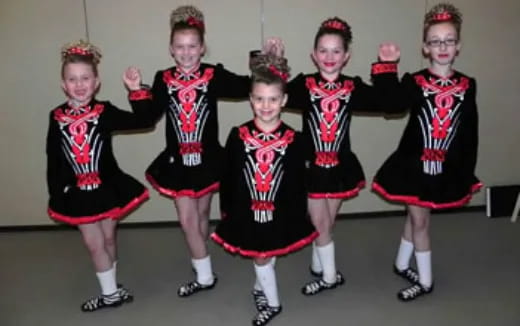 a group of girls in black and red dresses