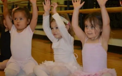 a group of girls in white dresses