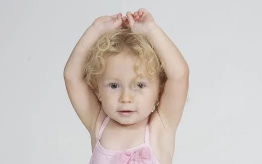 a child with her hair in the air