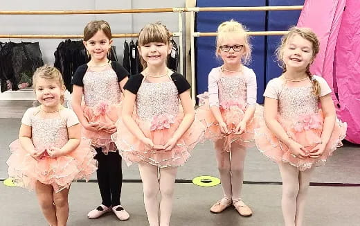 a group of girls in dresses