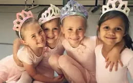 a group of girls wearing pink hats