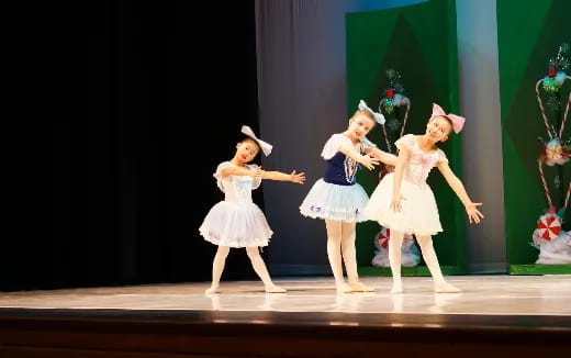 a group of girls dancing on a stage