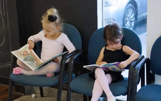 a couple of girls sitting in chairs