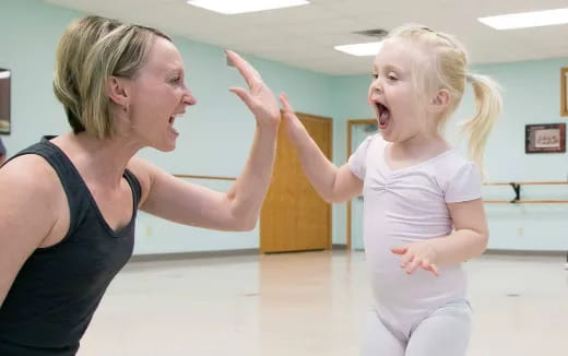 a woman and a girl dancing