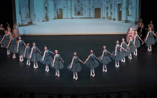 a group of girls dancing on a stage