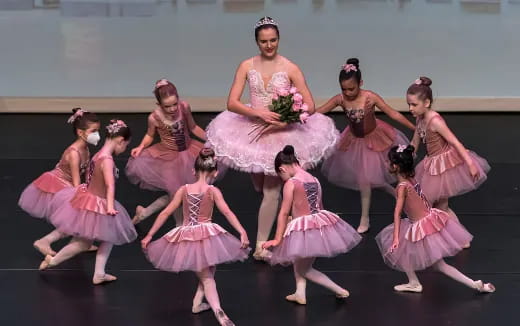 a group of women in dresses dancing