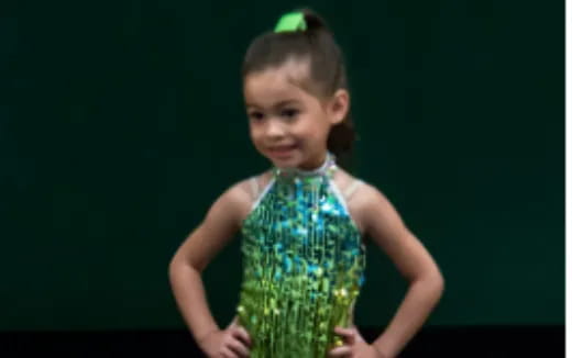 a little girl in a green dress
