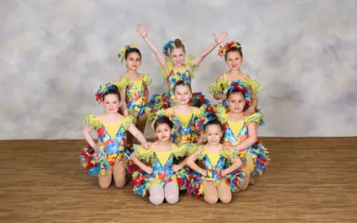 a group of children in colorful dresses