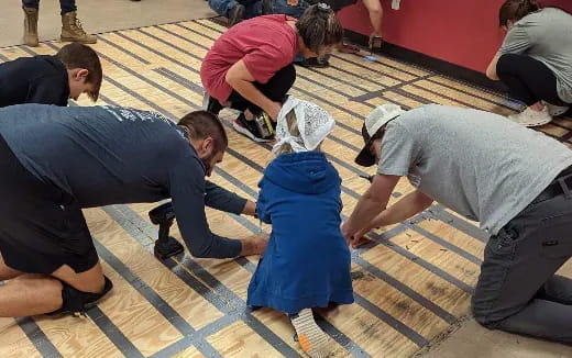 a group of people working on a floor