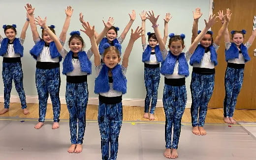 a group of girls in blue karate uniforms
