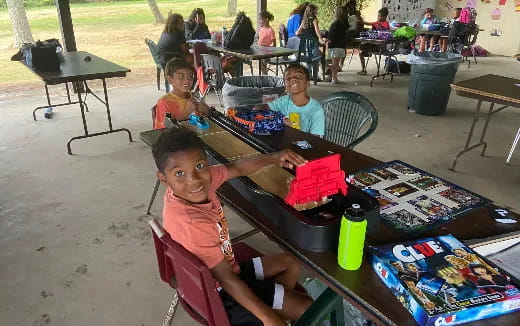 a group of children sitting at a table