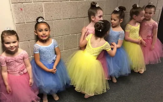 a group of children in dresses