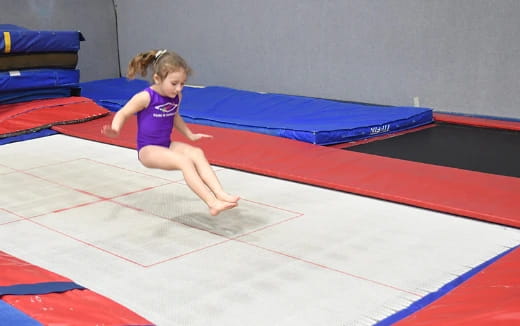 a girl running on a mat