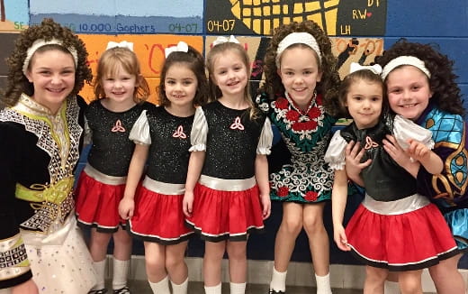 a group of girls in matching outfits