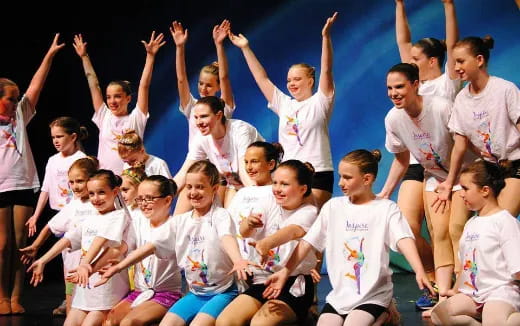 a group of children in white shirts