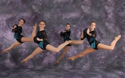 a group of women in swimsuits jumping in the air