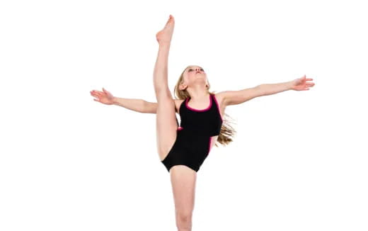 a woman in a black leotard with her arms up