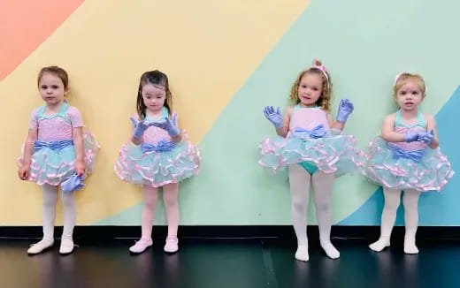 a group of girls in dresses