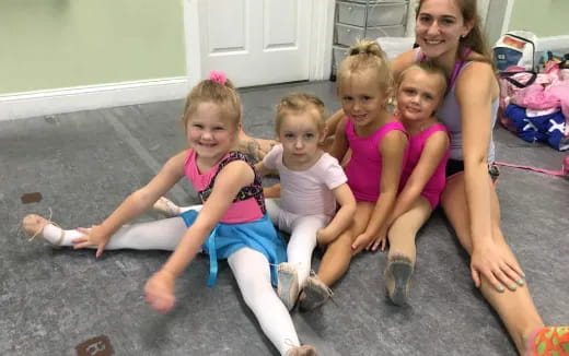 a group of girls sitting on the floor