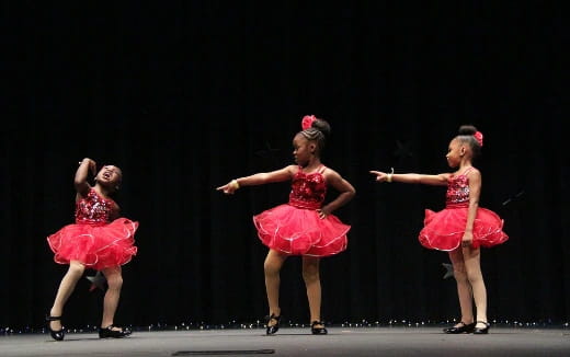 a group of women dancing on a stage