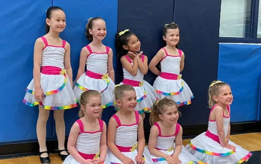 a group of girls in dresses