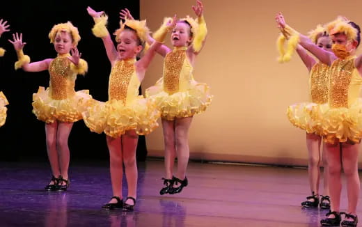 a group of women in yellow dresses