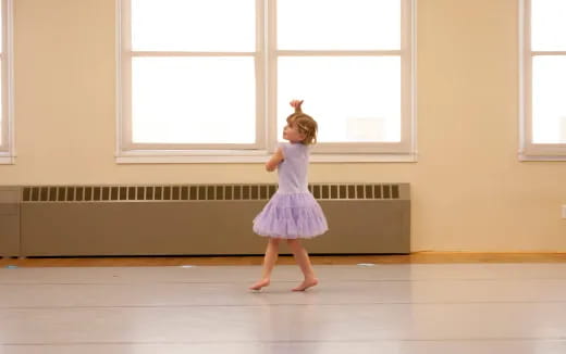 a girl in a dress dancing