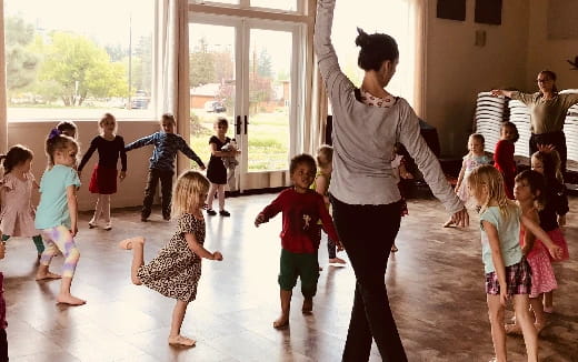 a person and children dancing