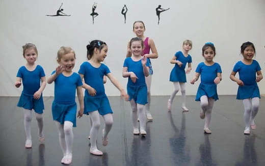 a group of girls in blue uniforms