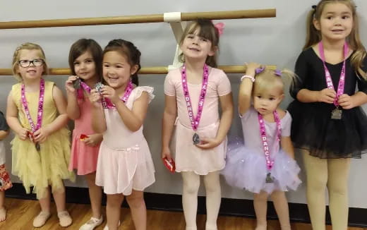 a group of girls in dresses