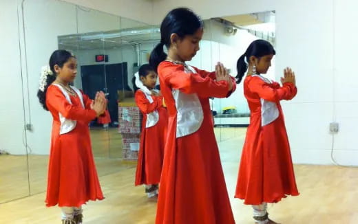 a group of girls in red dresses