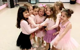 a group of girls in dresses