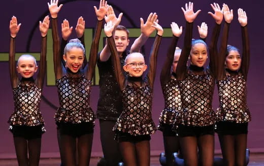 a group of women with their hands up